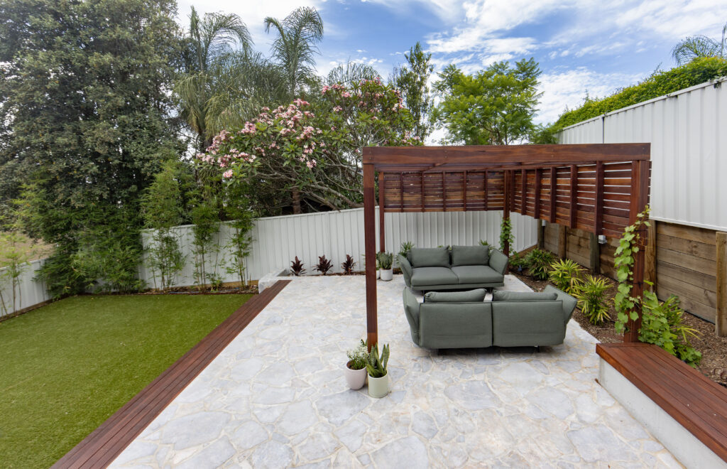 Landscape design and construct project in New Lambton completed with a timber pergola, crazy pave, synthetic turf, and an outdoor entertainment area.