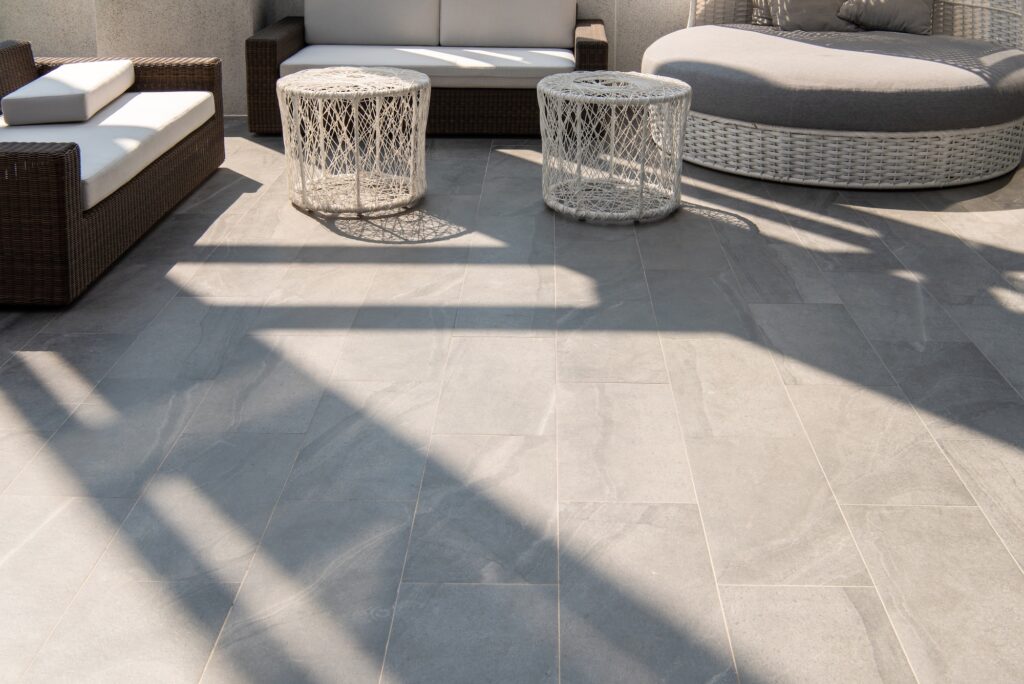 Outdoor terrace area with grey floor tile with sitting area
