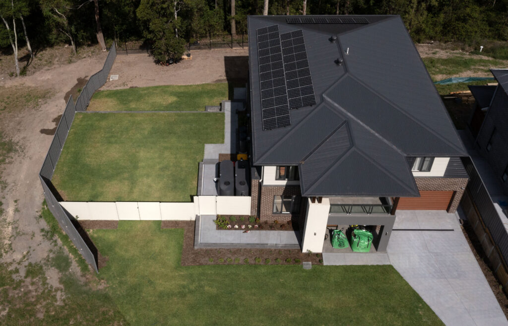 Newcastle landscaping project with excavation, retaining walls, drainage, turfing, planting, paving, and gardens.