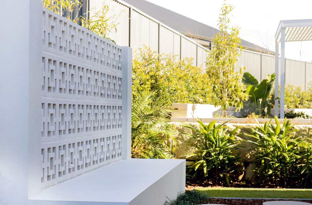 Commercial Domaine display home project in Cooranbong NSW consisting of decorative screening, turfing, retaining walls, steppers, fire pit space, concrete seating, planting and a pergola.