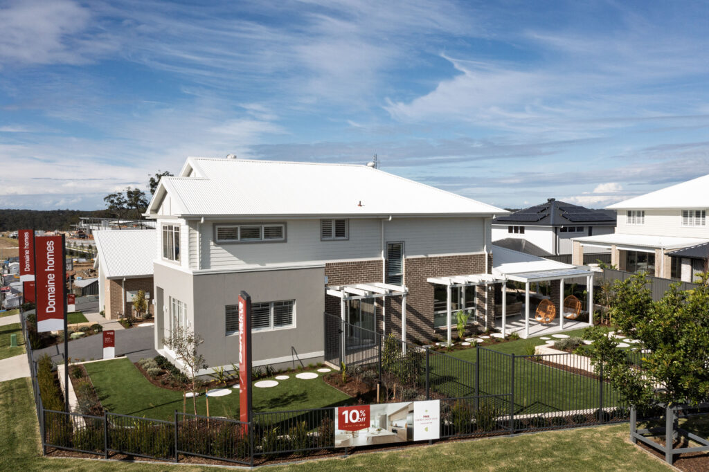 Commercial Domaine display home project in Cooranbong NSW consisting of decorative screening, turfing, retaining walls, steppers, fire pit space, concrete seating, planting and a pergola.