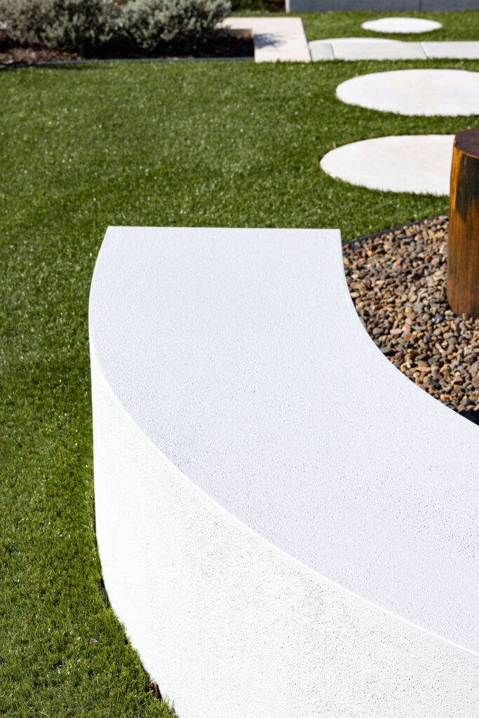 Commercial Domaine display home project in Cooranbong NSW consisting of decorative screening, turfing, retaining walls, steppers, fire pit space, concrete seating, planting and a pergola.