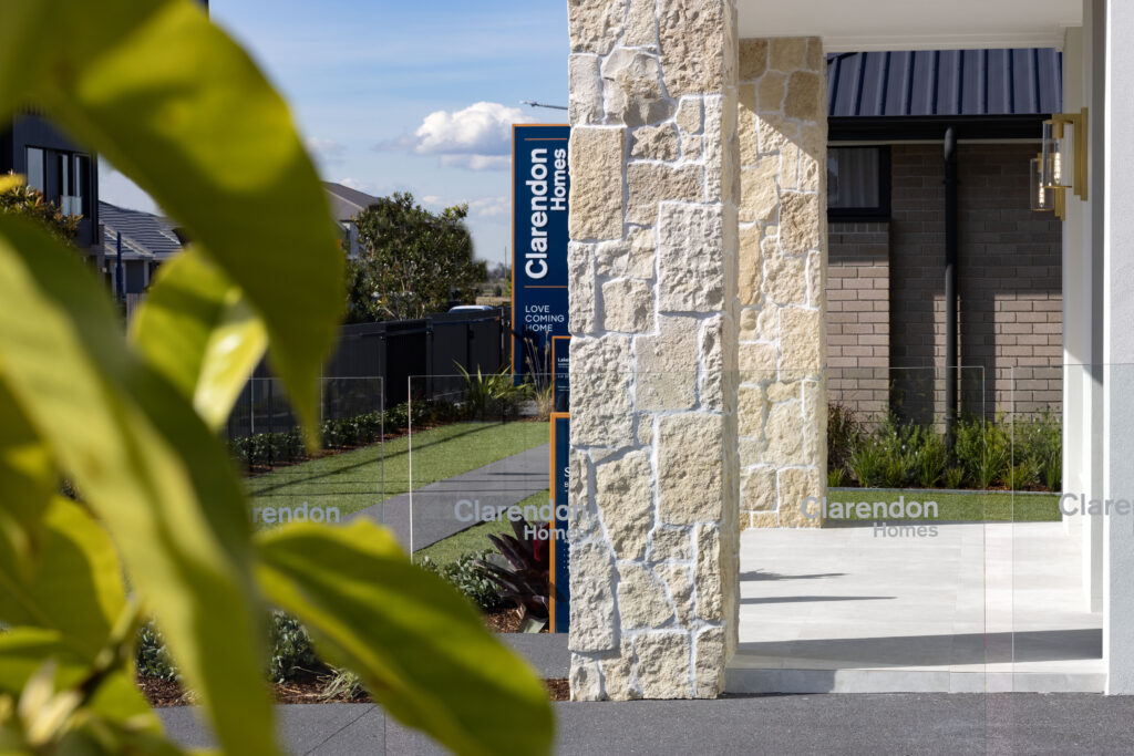 Display home landscaping with stone cladding pillars, planting and glass fencing Newcastle NSW and Hunter Valley NSW