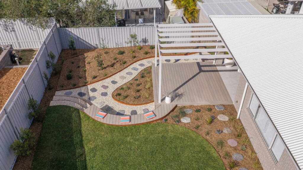 Aerial view of the finished rear yard in this Corlette native garden project, with curved path and seating