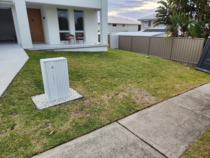 Native garden design Corlette front yard before landscaping, plain lawn and colorbond fencing