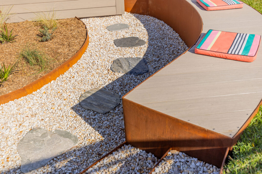 Stepping stone and gravel path detail beside the curved garden seat in Corlette