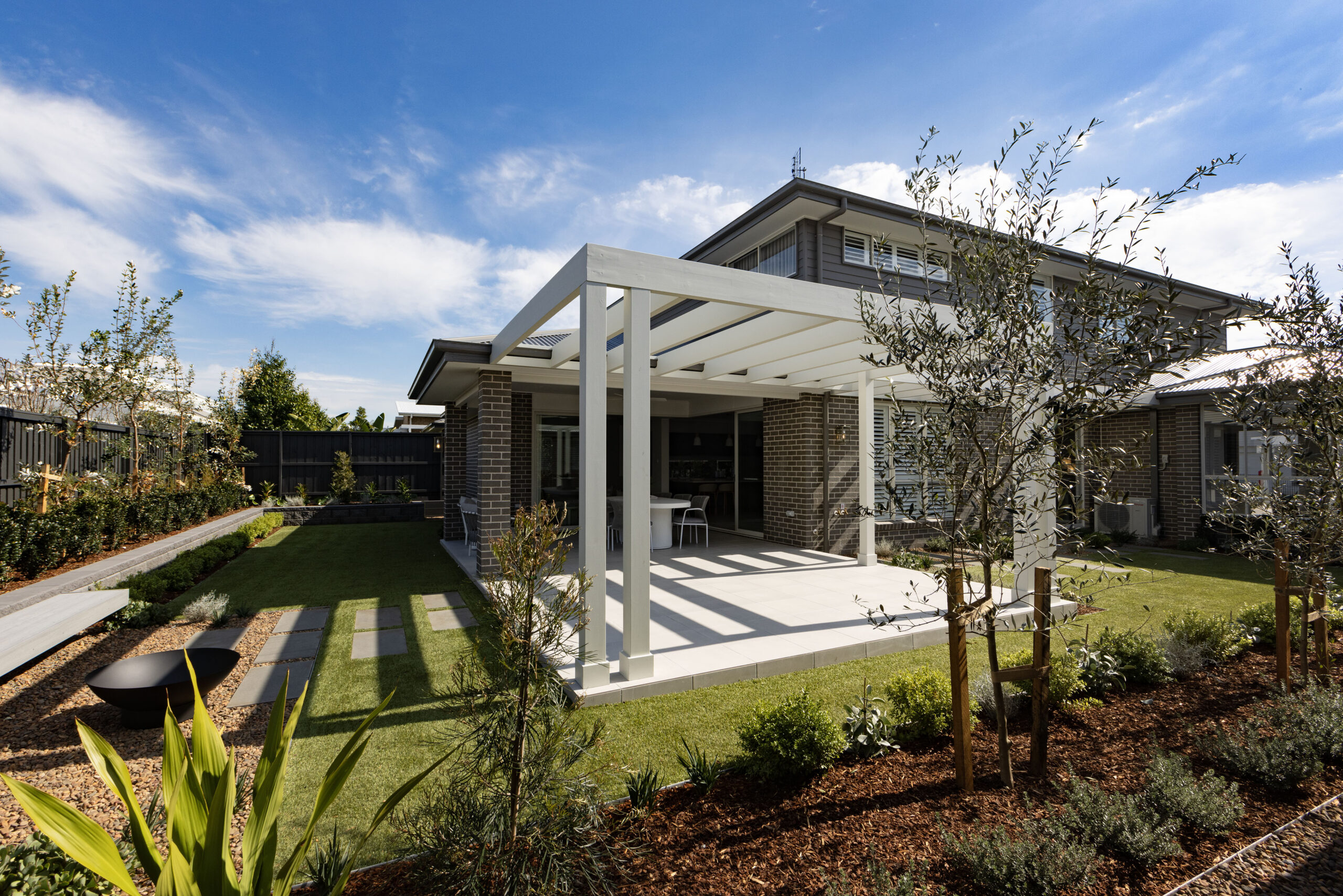 Finished alfresco area and garden beds at the Cooranbong display home, completed by Jason Reading Landscapes