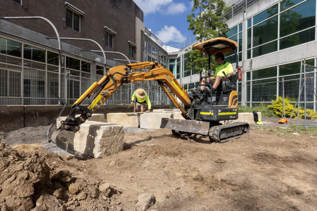 Checking sandstone log alignment during construction of the cultural connection space at John Hunter Hospital