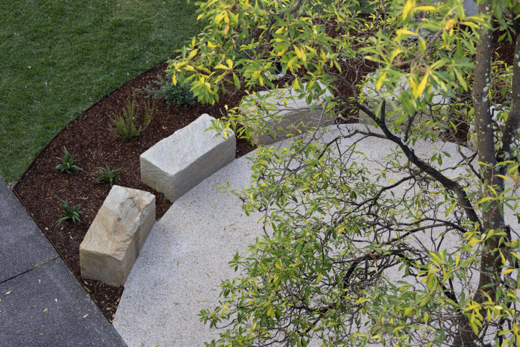 Sandstone seating along the curved pathway edge in the John Hunter Hospital cultural connection space