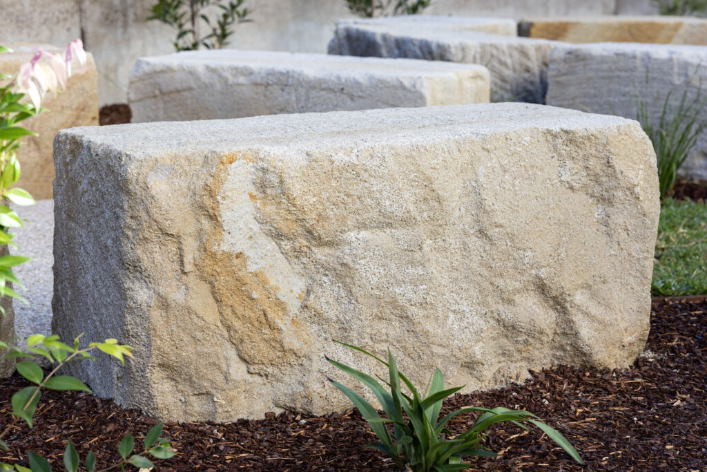 Low-angle detail of sandstone seating and concrete pad at John Hunter Hospital