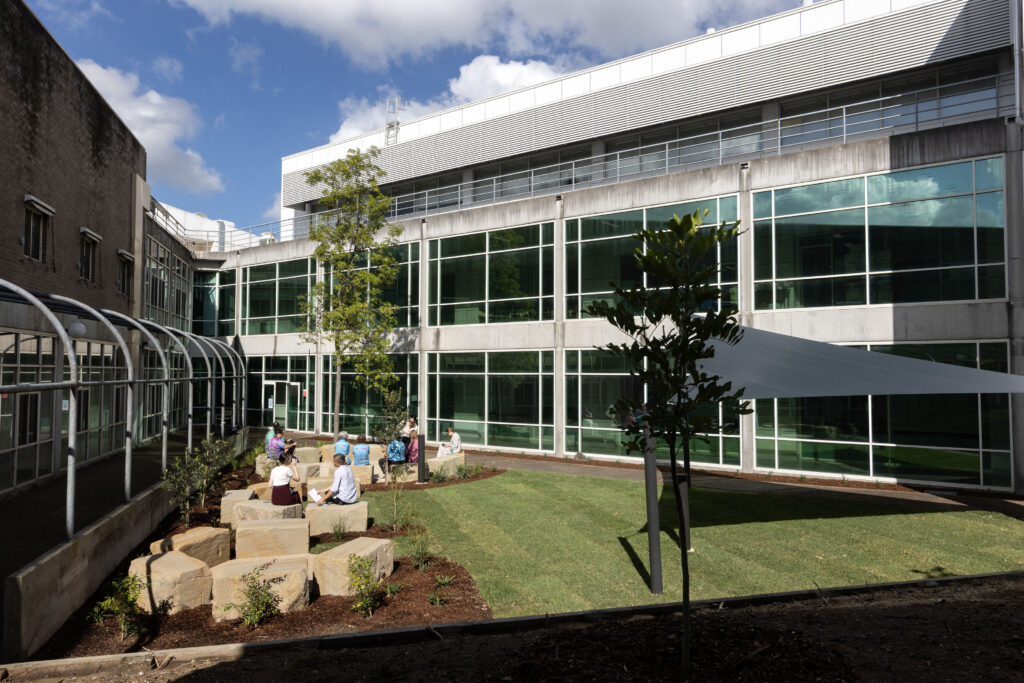 Hospital staff gathering in the cultural connection space courtyard at John Hunter Hospital