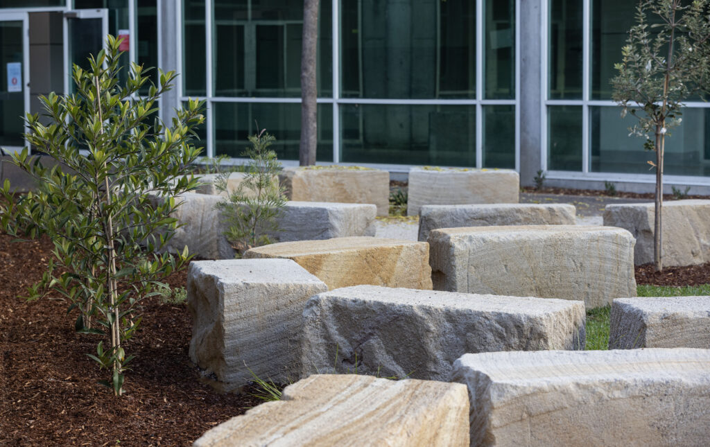 Full view of the completed cultural connection space at John Hunter Hospital, including seating and native planting