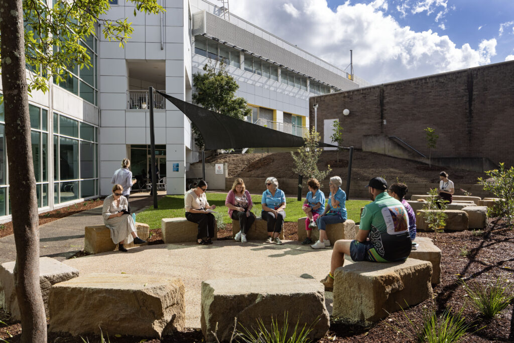 Staff and volunteers gathered in the yarning circle at John Hunter Hospital