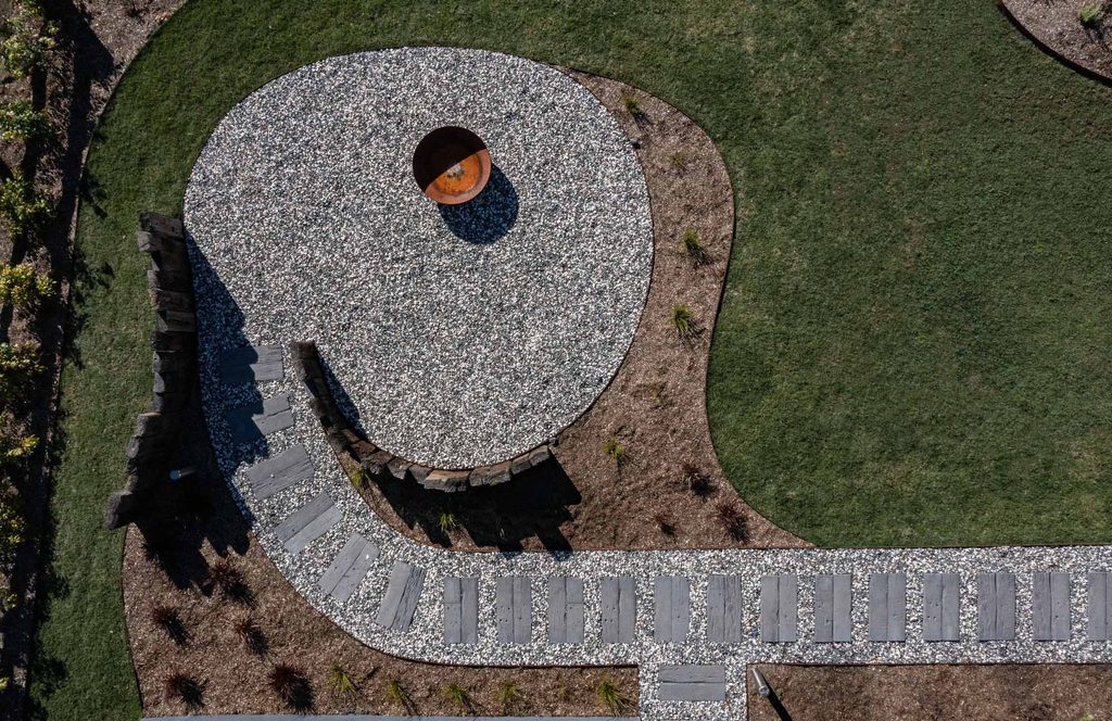 Close aerial view of the circular fire pit area and connecting stepping stone pathway