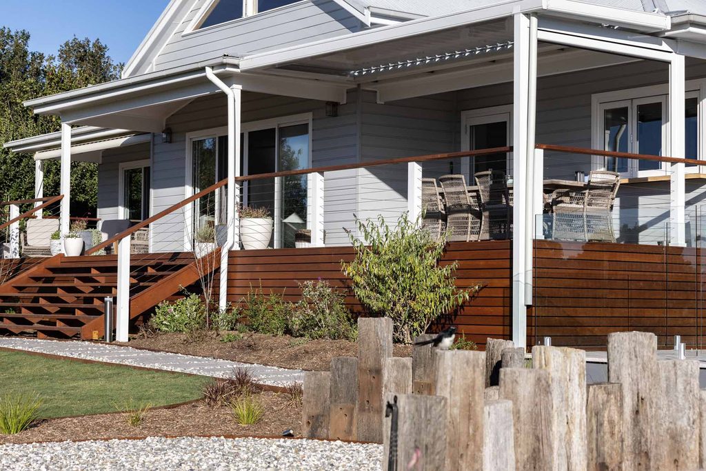 Finished house and deck exterior in Pokolbin with railway sleeper feature wall in the foreground