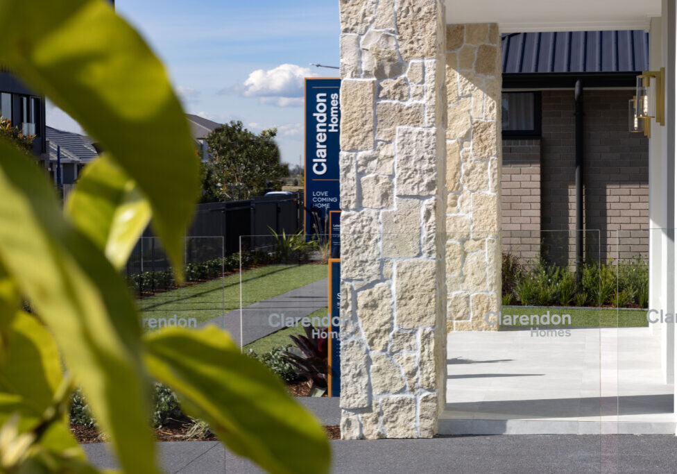 Display home landscaping with stone cladding pillars, planting and glass fencing Newcastle NSW and Hunter Valley NSW