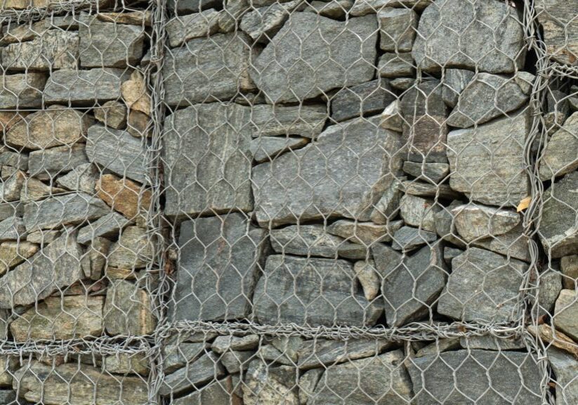 Mesh and stone fence, close-up of gabion for use in civil engineering, road building landscaping