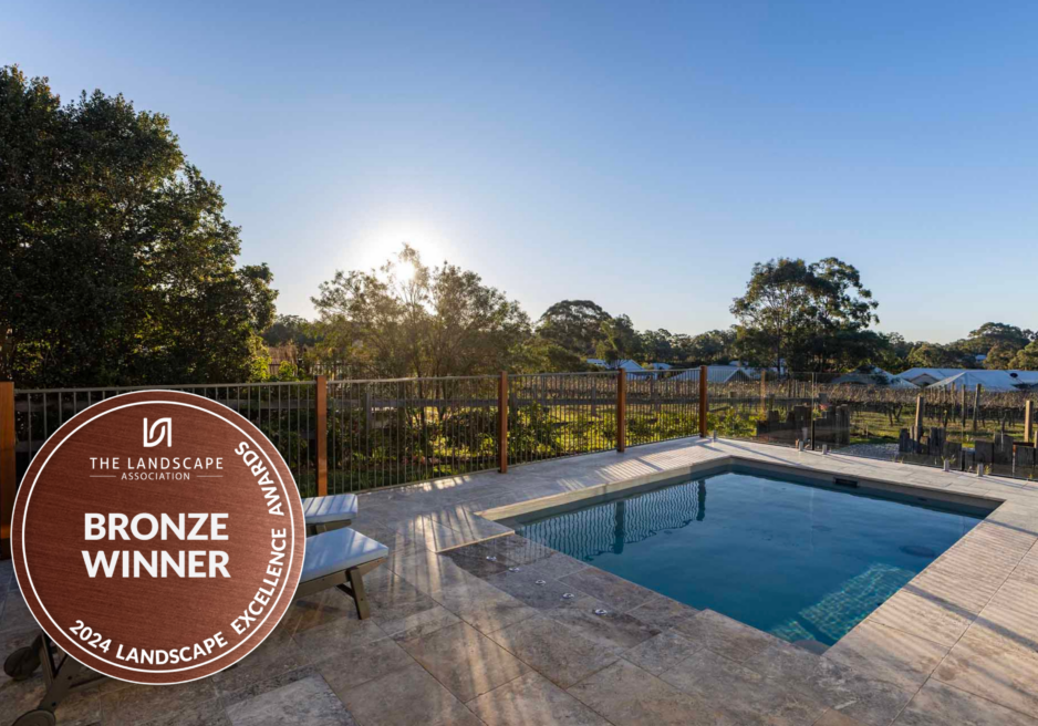 Finished pool landscaping Pokolbin project with frameless glass fencing framing an uninterrupted vineyard view